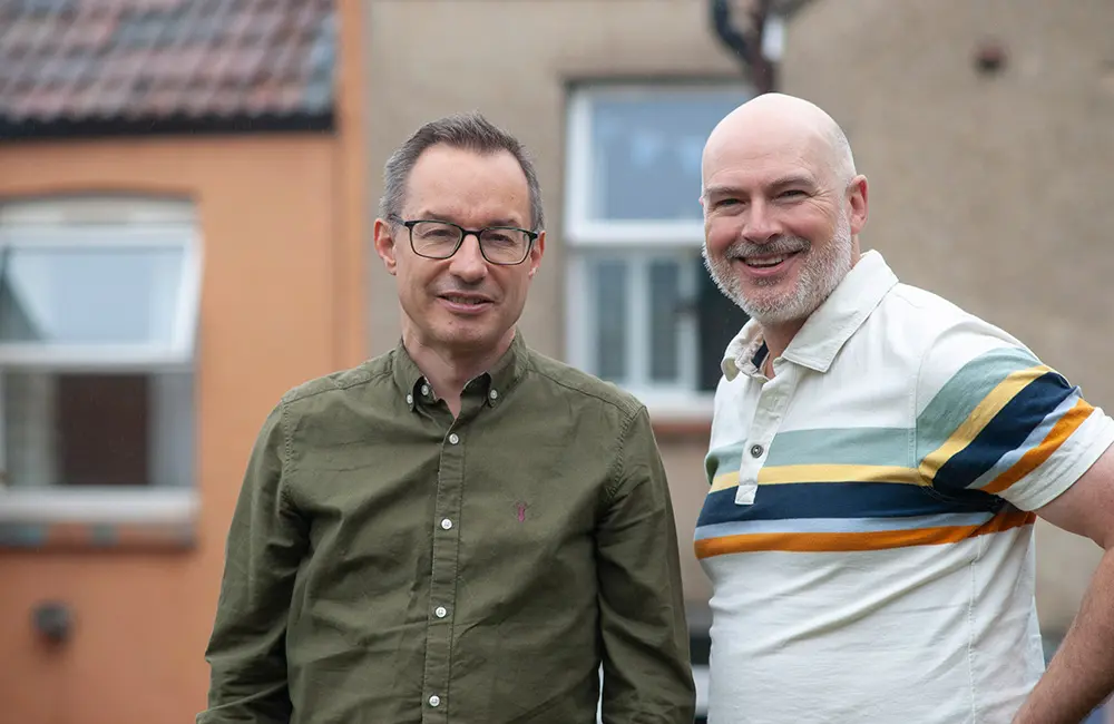 Inside Travel Group Founders Simon King & Alastair Donnelly stand outside buildings