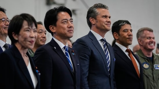 Japanese Defense Minister Shinjiro Koizumi, center left, and U.S. Defense Secretary Pete Hegseth, center right, with Japanese Prime Minister Sanae Takaichi, left, watch President Donald Trump speak to members of the military aboard the USS George Washington, an aircraft carrier docked at an American naval base, in Yokosuka, Tuesday, Oct. 28, 2025. (AP Photo/Mark Schiefelbein)(AP)