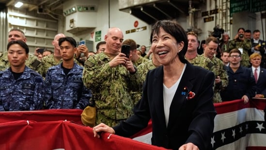 Takaichi listens to Trump speak to members of the military aboard the USS George Washington, an aircraft carrier docked at an American naval base, in Yokosuka, Tuesday, Oct. 28, 2025. (AP Photo/Mark Schiefelbein)(AP)