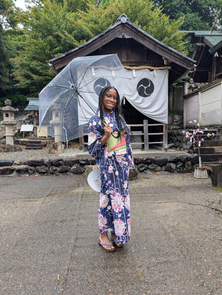 Young woman dressed in blue floral kimono.