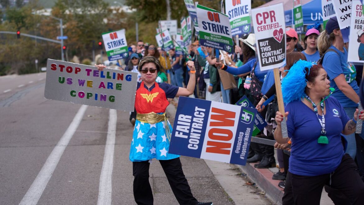 Hawaii Evening Briefing: Oct. 14, 2025 Kaiser Permanente health care workers hold signs and chant slogans while on strike in front of the Kaiser Permanente San Diego Medical Center Tuesday, Oct. 14, 2025, in San Diego. (AP Photo/Gregory Bull)