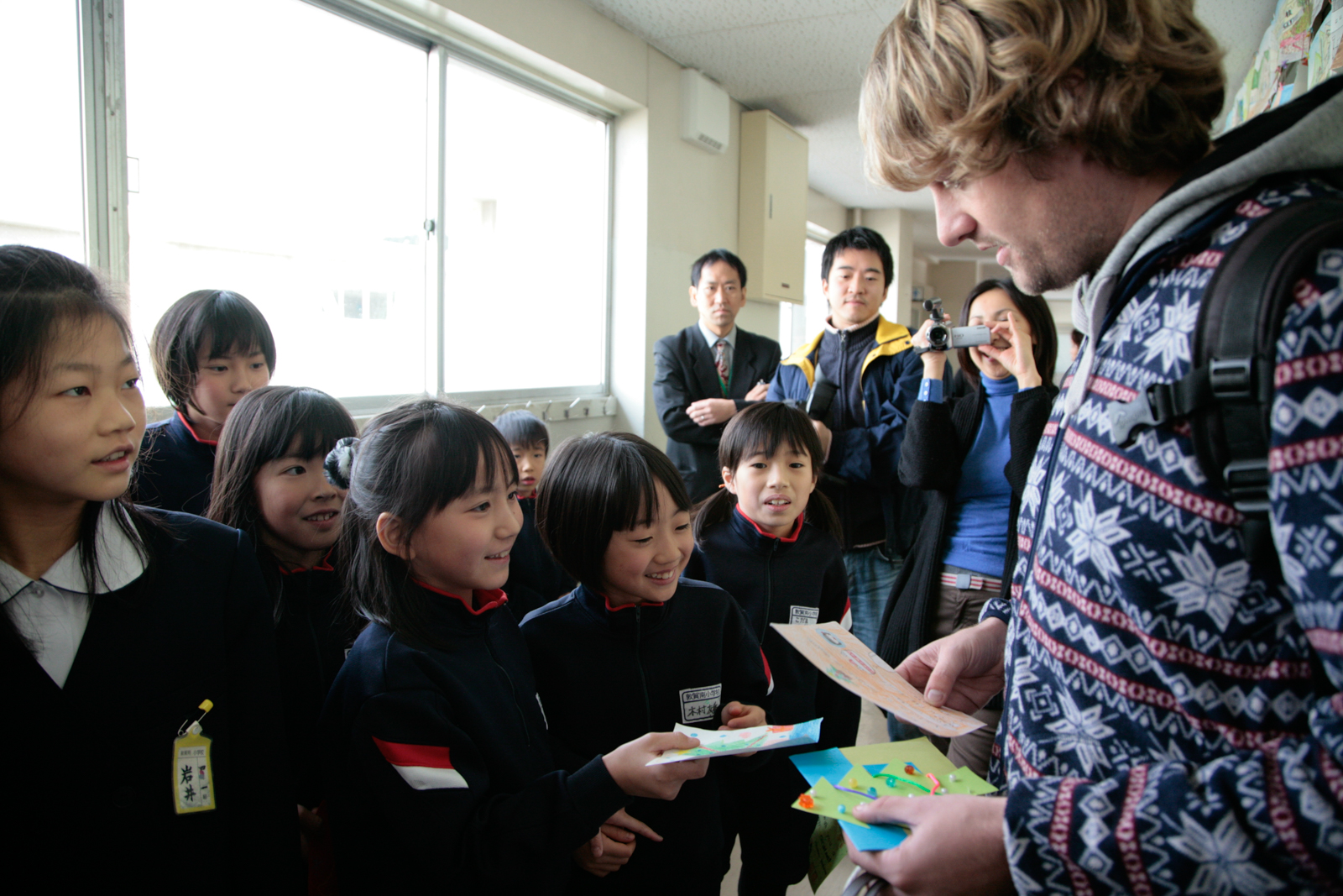 School children give gifts to volunteer helping after the 2011 earthquake