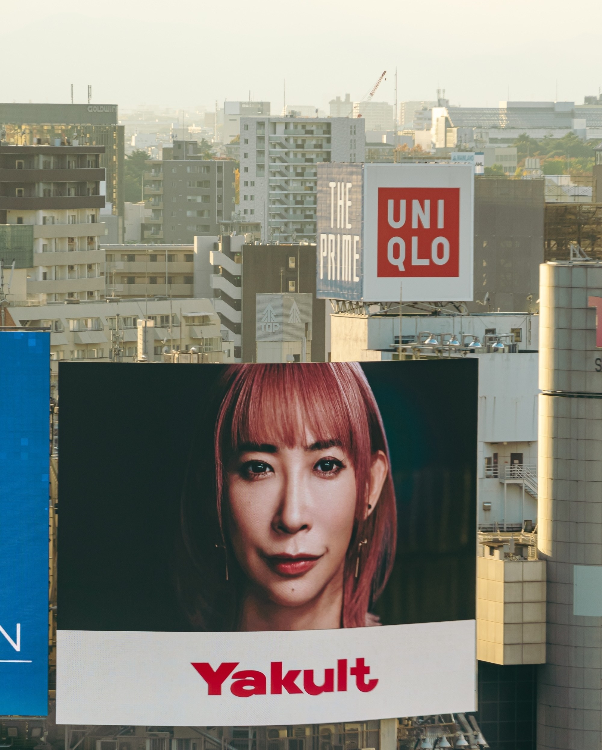 A billboard for Yakult featuring a woman’s face.