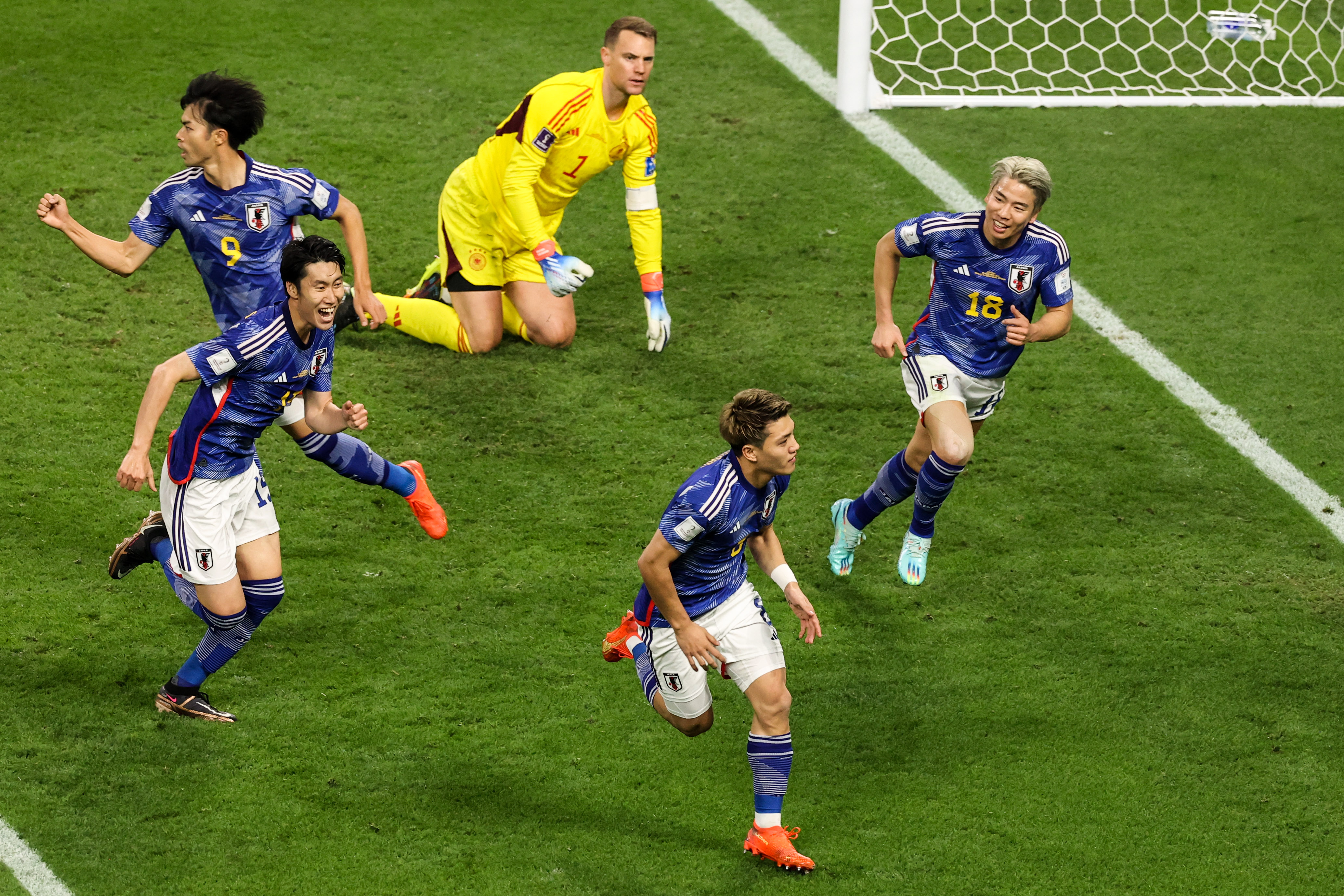Japan players celebrate Doan Ritsu's goal against Germany at the 2022 World Cup.
