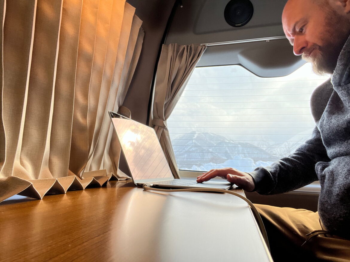 I ditched pre-booked ski hotels in Japan for a campervan road trip, and I don’t regret it Working at the countertop with Happo-One in the background