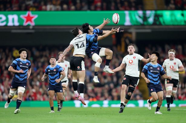Louis Rees-Zammit of Wales and Yoshitaka Yazaki of Japan battle for a high ball