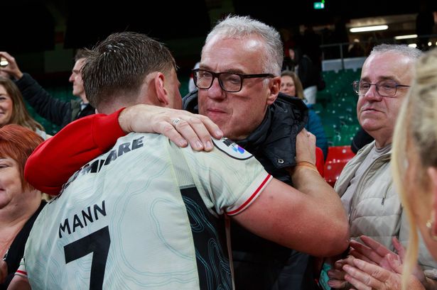 Alex Mann embraces his family