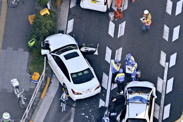Investigators inspect the scene of a car accident