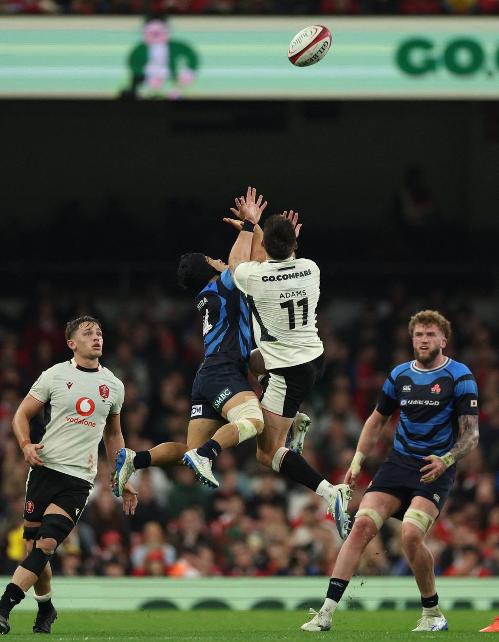 Japan’s Kippei Ishida (middle left) and Wales’ Josh Adams compete for a high ball. Photo: AFP