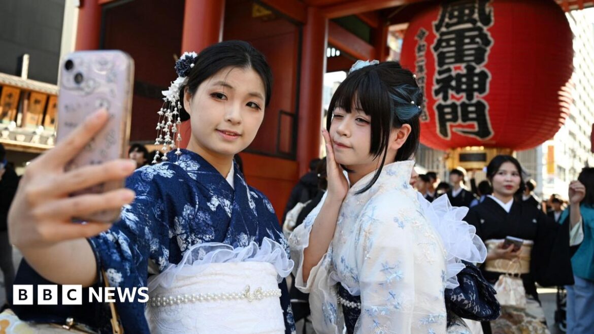 Japan tourism and retail stocks slide after China row Two Chinese tourists wear kimonos as they visit the Sensoji Temple in the Asakusa district of Tokyo on November 15, 2025.