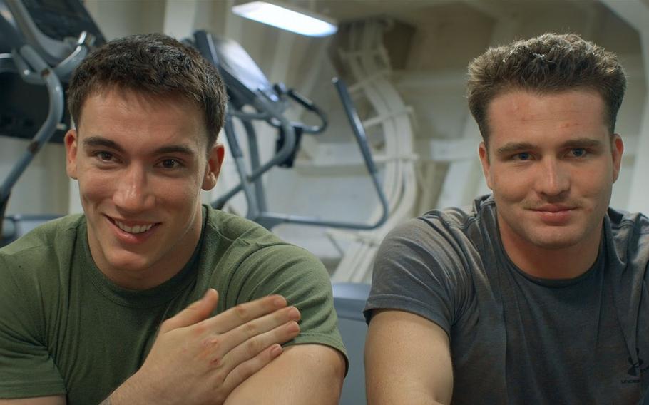 Two U.S. Marines pose for a photo.