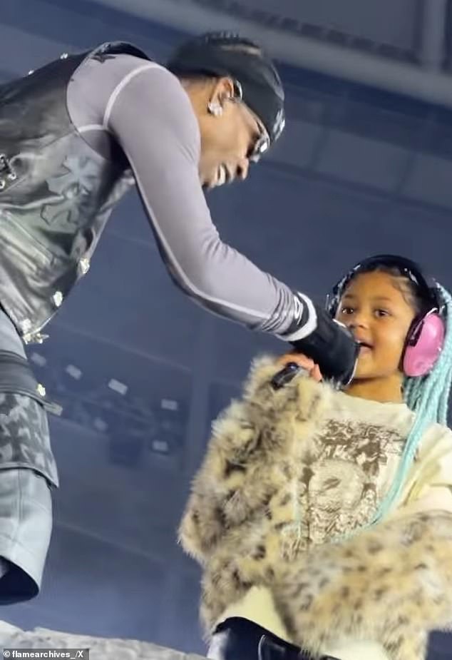 In a fan video shared to X, Scott brought out his daughter on stage with him as he belted out lyrics to the track Thank God from his 2023 album Utopia - which features the seven-year-old