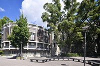 The junction between the round library section, an extension designed by Togo Murano, left, and the Gothic-style old library section with its many tall, narrow windows is seen on Kansai University's Senriyama Campus in Suita, Osaka Prefecture, Sept. 1, 2025. (Mainichi/Tsutomu Koseki)