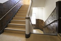 The staircase in the old library is seen on Kansai University's Senriyama Campus in Suita, Osaka Prefecture, Sept. 1, 2025. Hallways and stairways are adorned with textured tiles up to about 1.5 meters high, with plaster applied above. (Mainichi/Tsutomu Koseki)