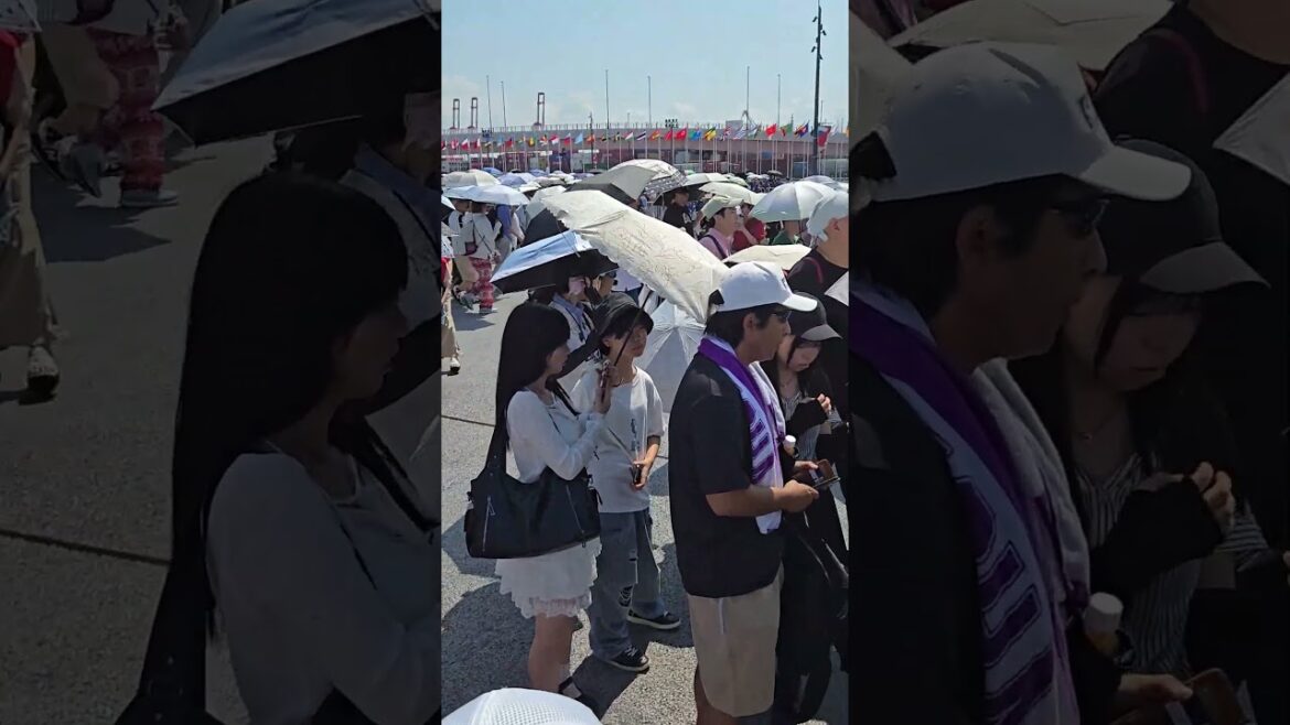 Visitors Wait Under Umbrellas as They go Through Security Before Entering Expo Osaka, Japan.