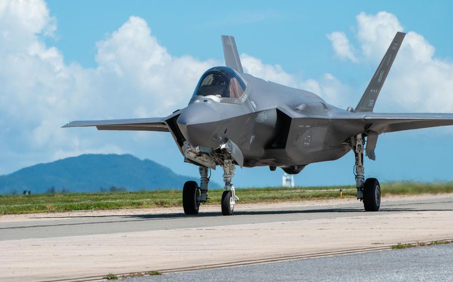 An F-35A Lightning II lands on a tarmac with a birght blue sky behind it. 