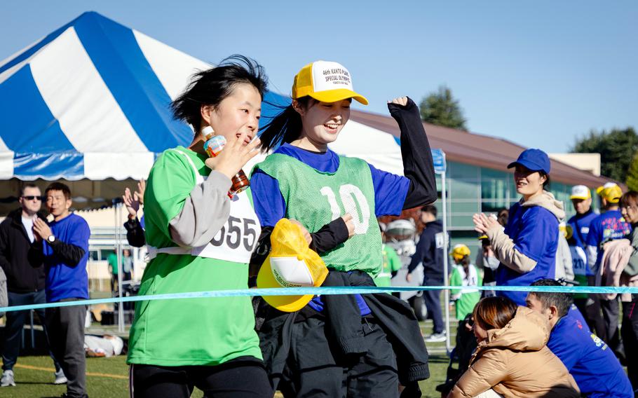 Two runners approach a finish line.