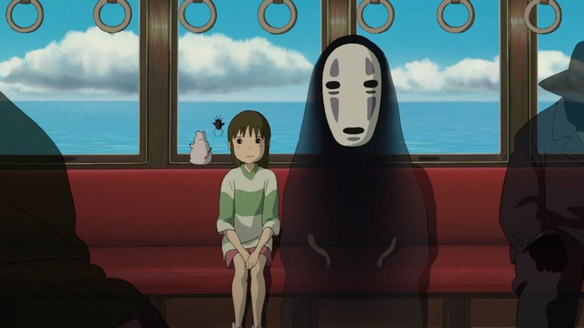 Chihiro and No-Face sitting in a train carriage during Spirited Away