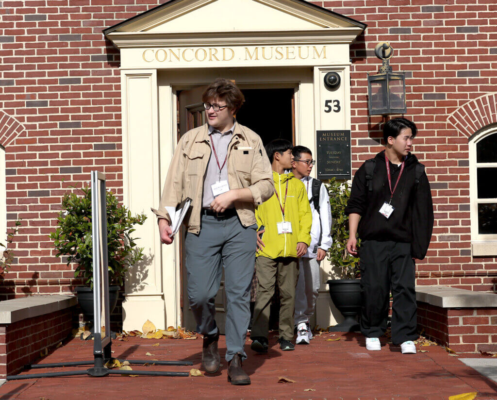 Jack McCarthy, right, the coordinator of international relations for the town of Nanae, Japan, leads his student delegration after a visit to the Concord Museum on Tuesday, October 28, 2025. Ken McGagh/The Concord Bridge