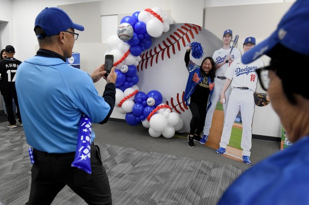 Mayor George Chen takes pictures during “International Dodgers Celebration,” with...