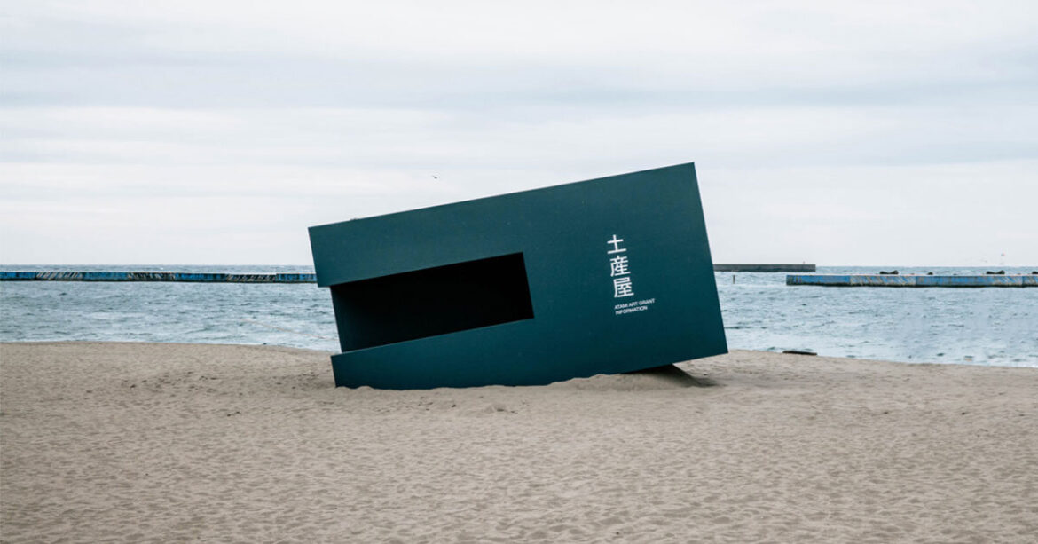 buried souvenir shop on japanese shoreline reflects on tourism, land, and memory