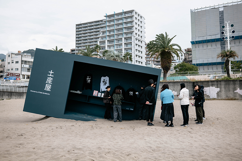 buried souvenir shop on japanese shoreline reflects on tourism, land, and memory