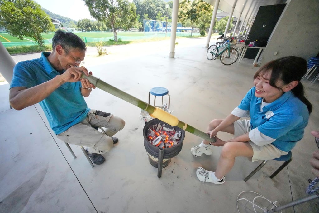 Staff make Baumkuchen, a German layered cake, during a workshop of Juchheim Ninoshima Welcome Centre and Outdoor Activity Camp at Ninoshima island in Hiroshima, western Japan. Photo: AP