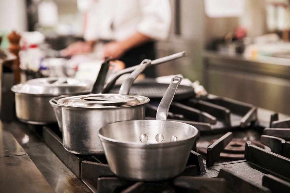 Cook working at a restaurant stovetop