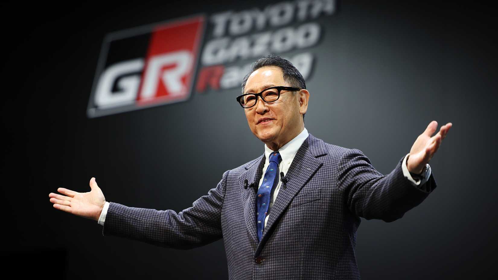 Akio Toyoda of Toyota in front of Toyota Gazoo Racing sign