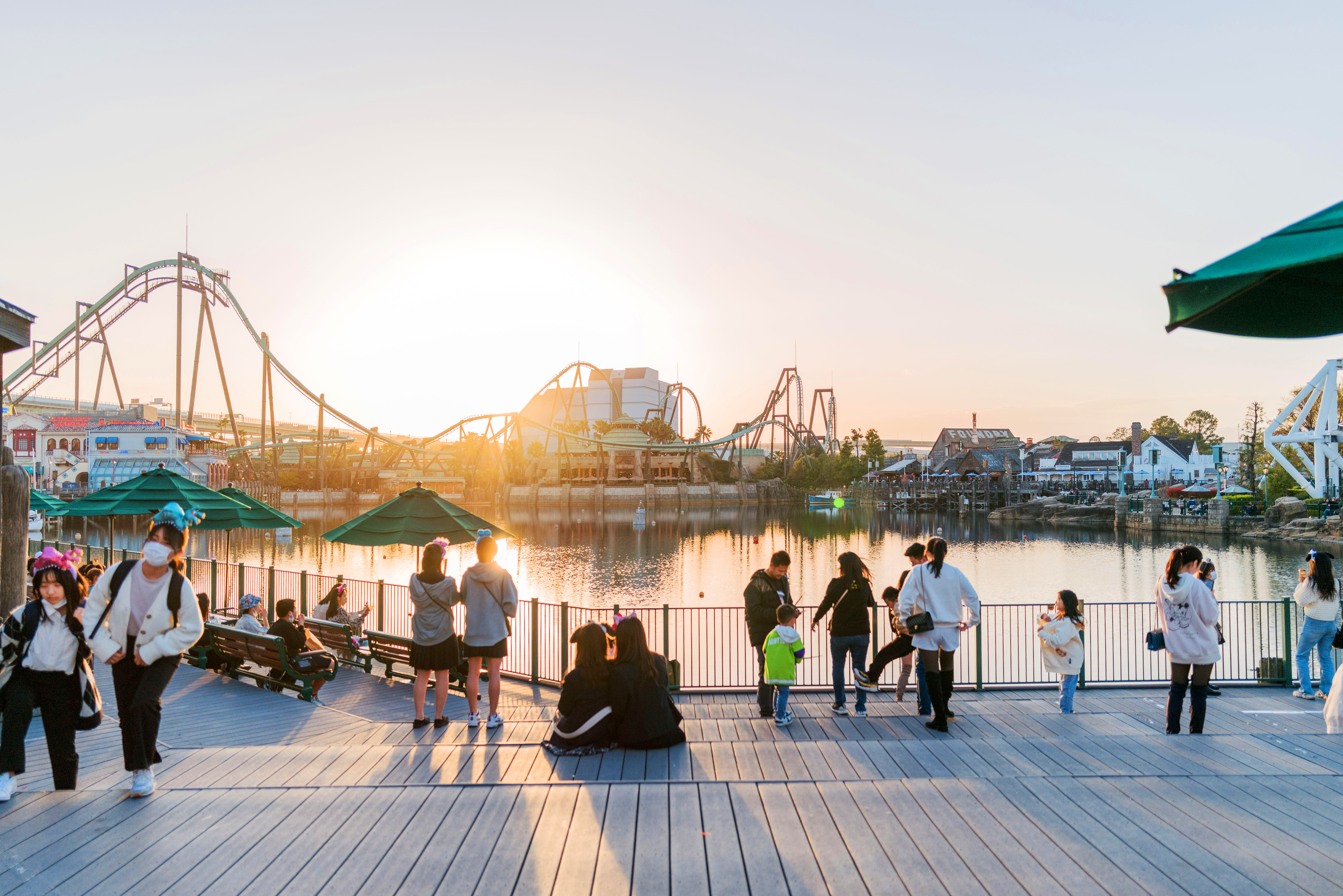 Sunset view of Universal Studios Japan pier, with rollercoasters in the background
