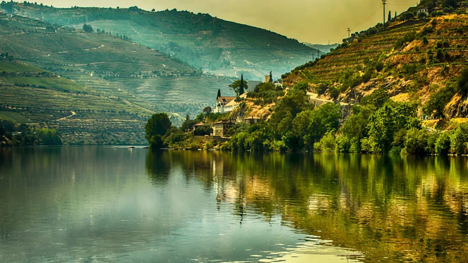Douro River Valley. Port Wine vineyards region. Travel and Ship Cruise area. Grape harvest time. Slow flow time of the year.	Fotisto Pizoto