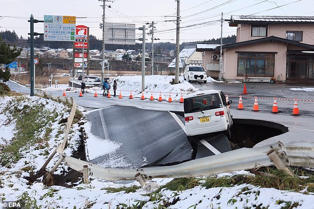 The UK Foreign Office has not warned against non-essential travel to Japan. Pictured: A car stranded on a collapsed road
