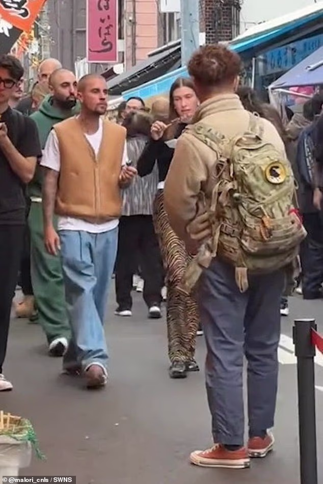 The couple both looked relaxed as they strolled through the crowded streets of the capital after grabbing food from Tsukiji Outer Market