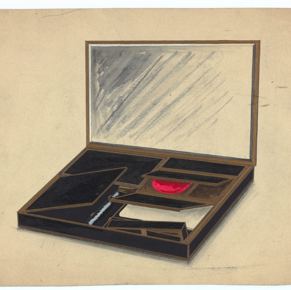 open box displaying various compartments and a red circular object