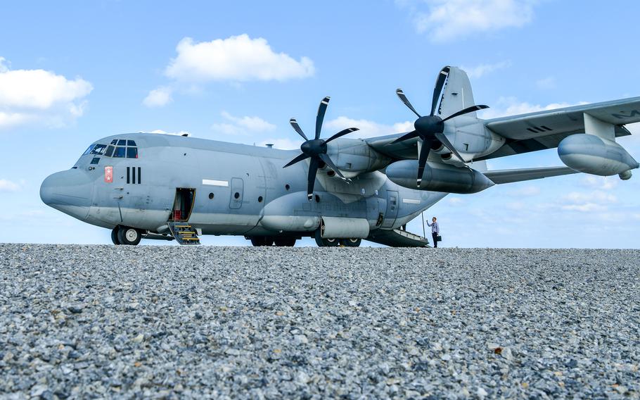 A KC-130J prepares to take off from a rocky island airstrip.