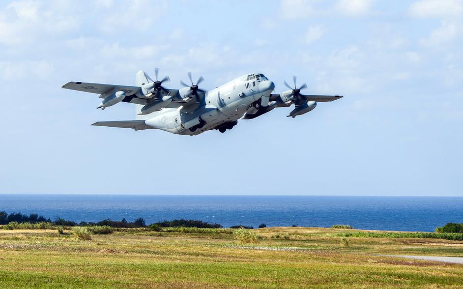 A KC-130J takes off from an island airfield.