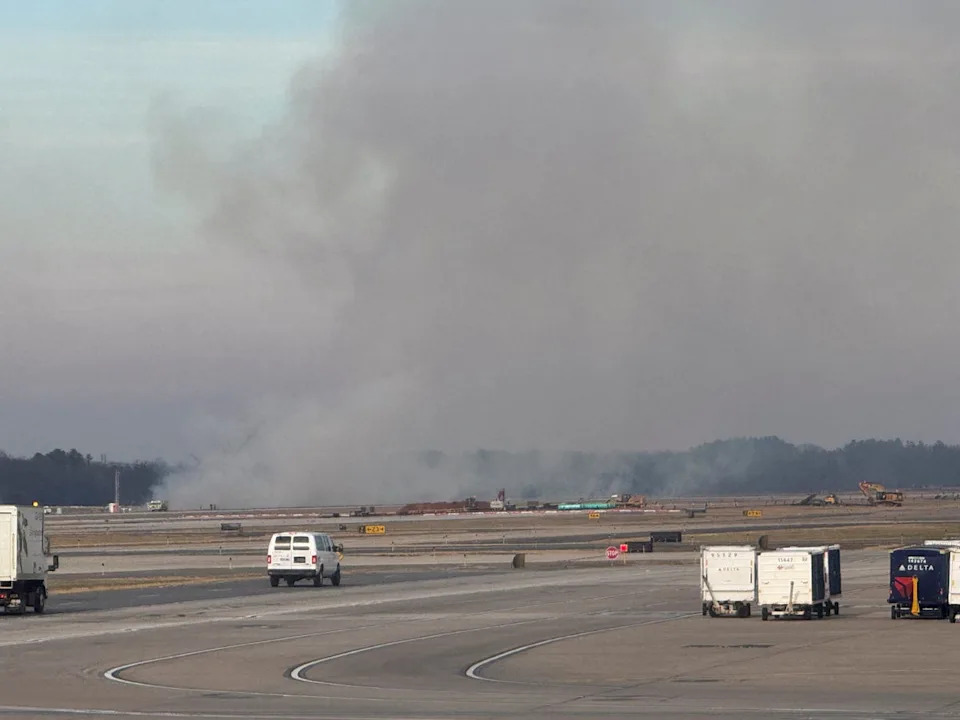 Smoke rising from a small brush fire that was ignited when a United Airlines flight lost engine power December 13 (HOUMAN HEMMATI via REUTERS)