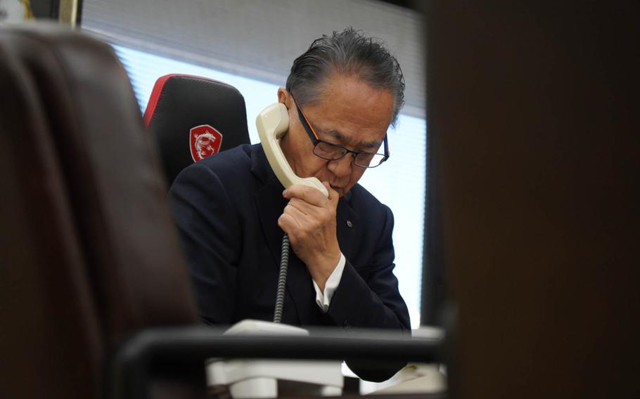 A Japanese official talks on the phone.