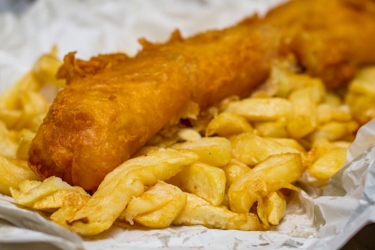 Traditional English jumbo sized Fish and Chips served in paper