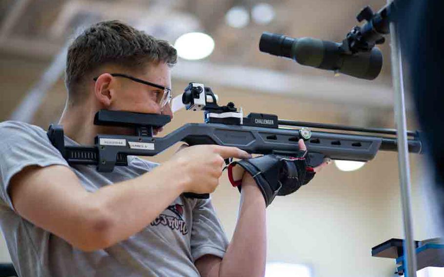 A JROTC cadet from Matthew C. Perry High School sets his sights before firing from the standing position during the Pacific East Regional Marksmanship Match at Marine Corps Air Station Iwakuni, Japan, Dec. 5, 2025.