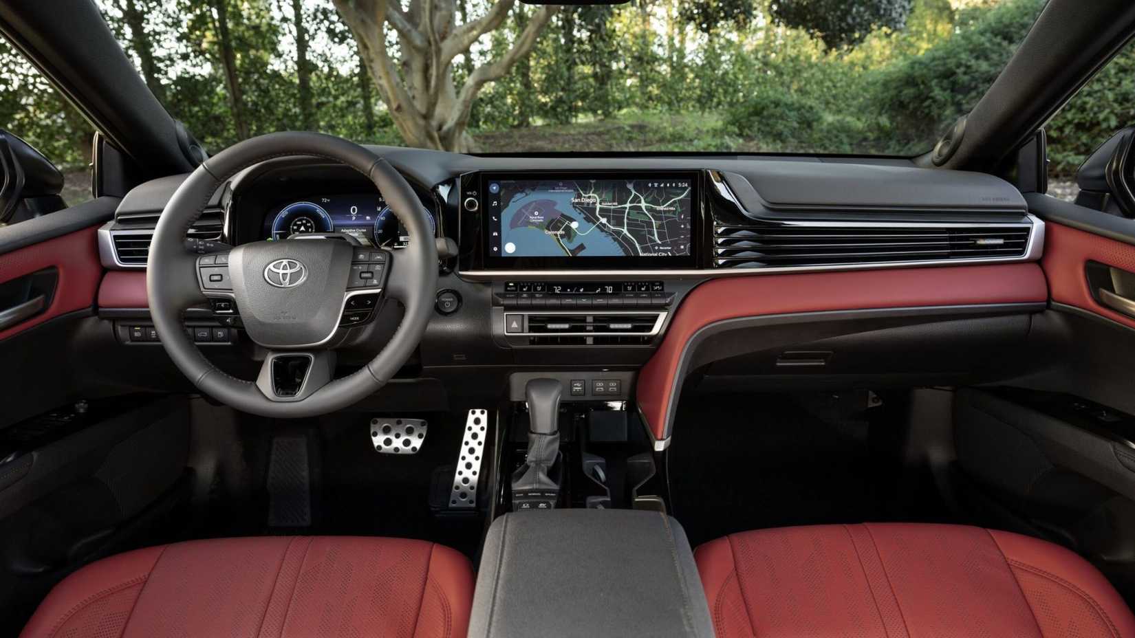 Shot of the cabin of a 2026 Toyota Camry XSE AWD with red leather shwoing the steering wheel and infotainment display.