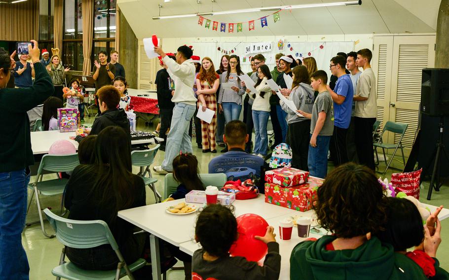 Kubasaki High School JROTC cadets sing Christmas carols at a community center.