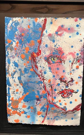 A painting shows a face.