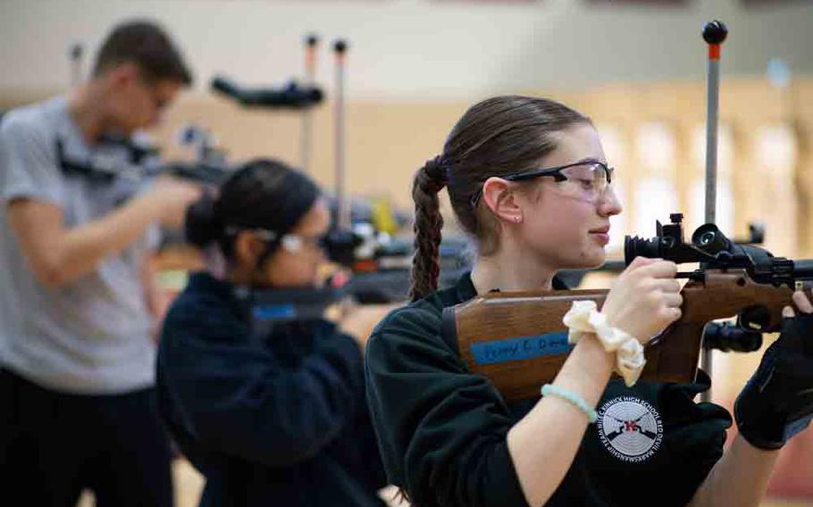 A JROTC cadet from Nile C. Kinnick High School sets her sights before firing from the standing position during the Pacific East Regional Marksmanship Match at Matthew C. Perry High School on Marine Corps Air Station Iwakuni, Japan, Dec. 5, 2025.