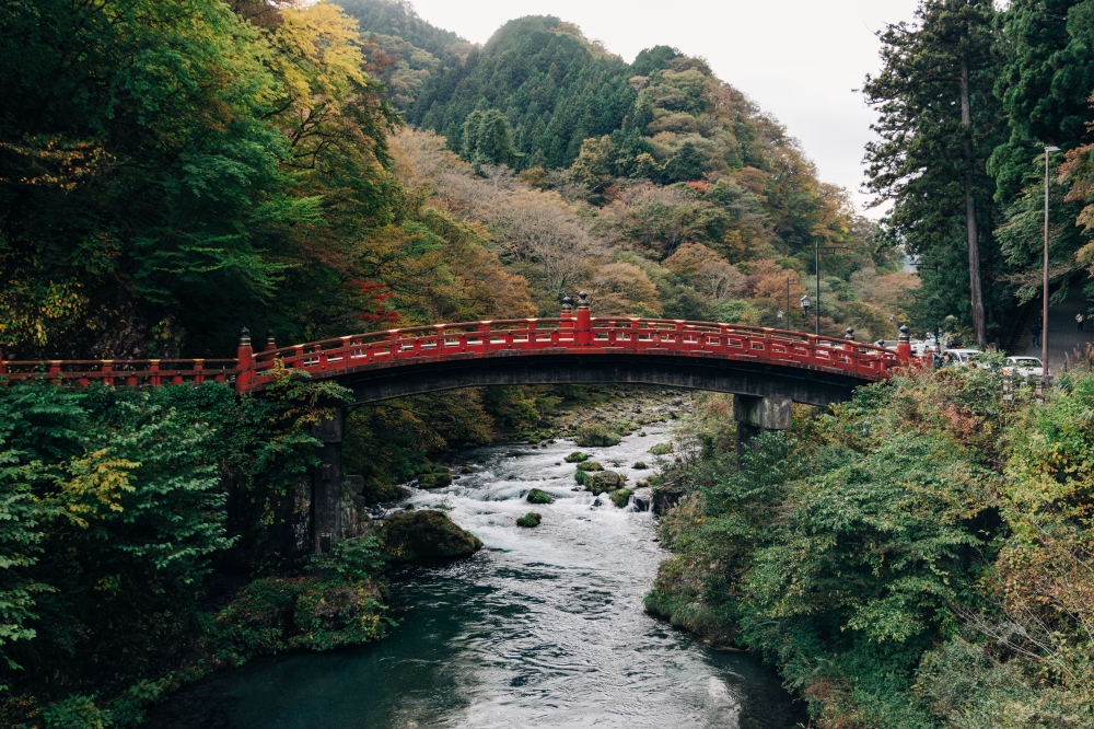 The Shinkyo Bridge in Nikko crossing over the Daiya River, surrounded by a beautiful, scenic view. — Picture by Japan National Tourism Organization
