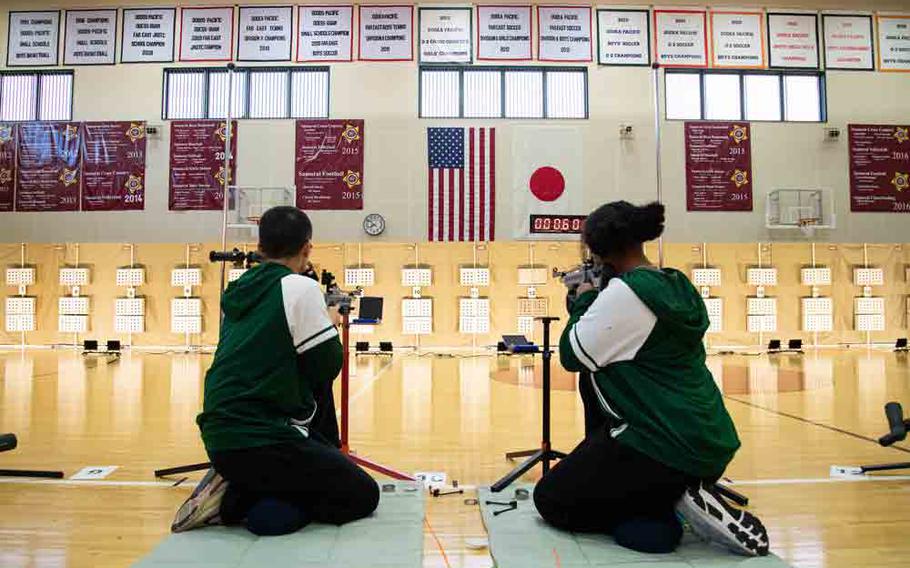 JROTC cadets from Robert D. Edgren Middle-High School fire from the kneeling position during the Pacific East Regional Marksmanship Match at Matthew C. Perry High School on Marine Corps Air Station Iwakuni, Japan, Dec. 6, 2025.