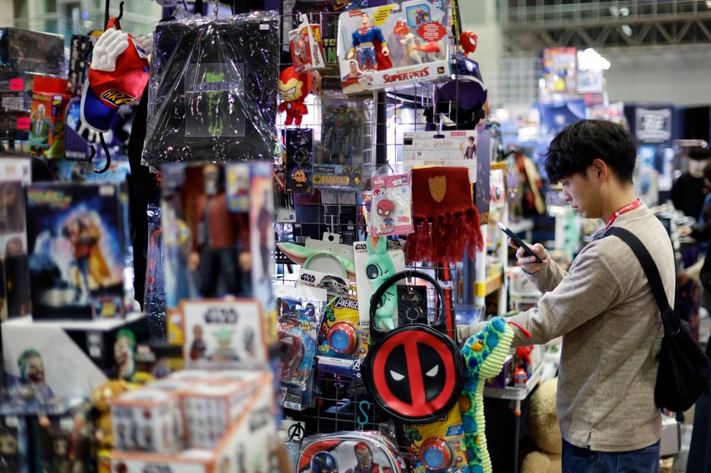 A visitor looks at products on sale at the Tokyo Comic Con 2025 in Chiba on Friday. As part of its “Cool Japan” strategy, Japan’s government has grand ambitions for anime, manga and games. Photo: EPA