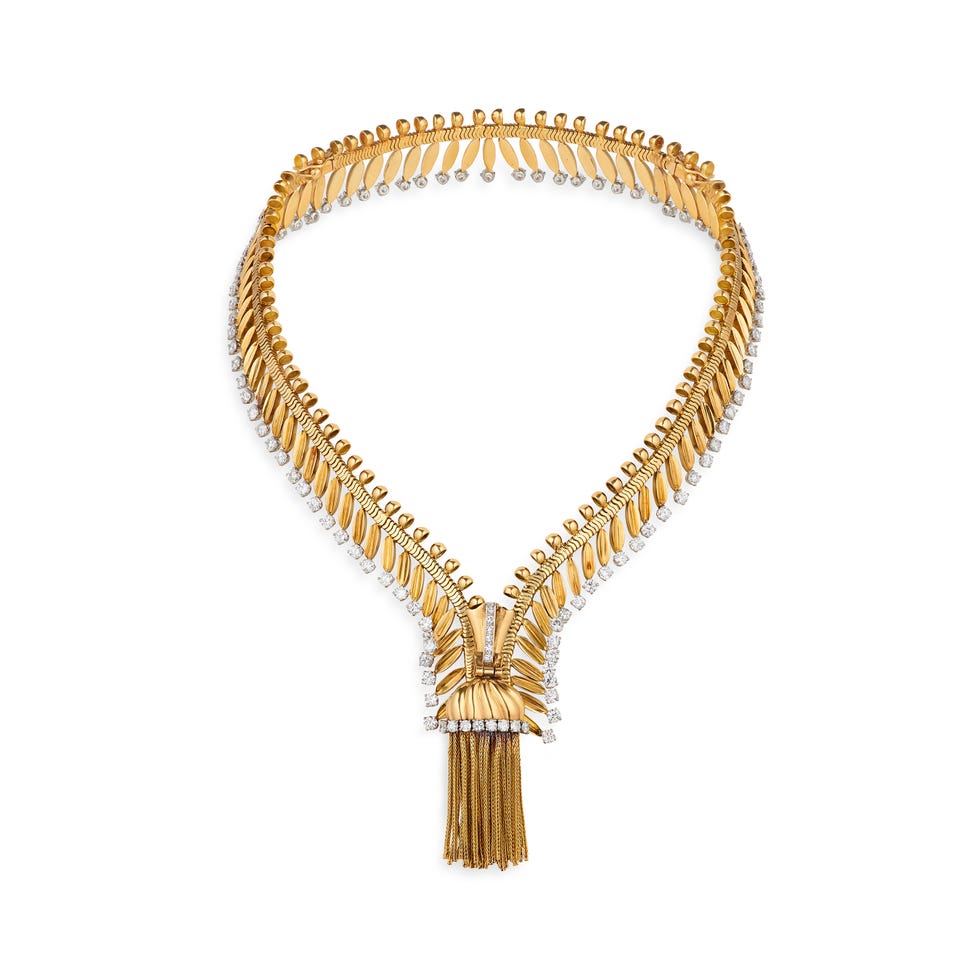 statement necklace featuring an intricate gold design with diamond accents