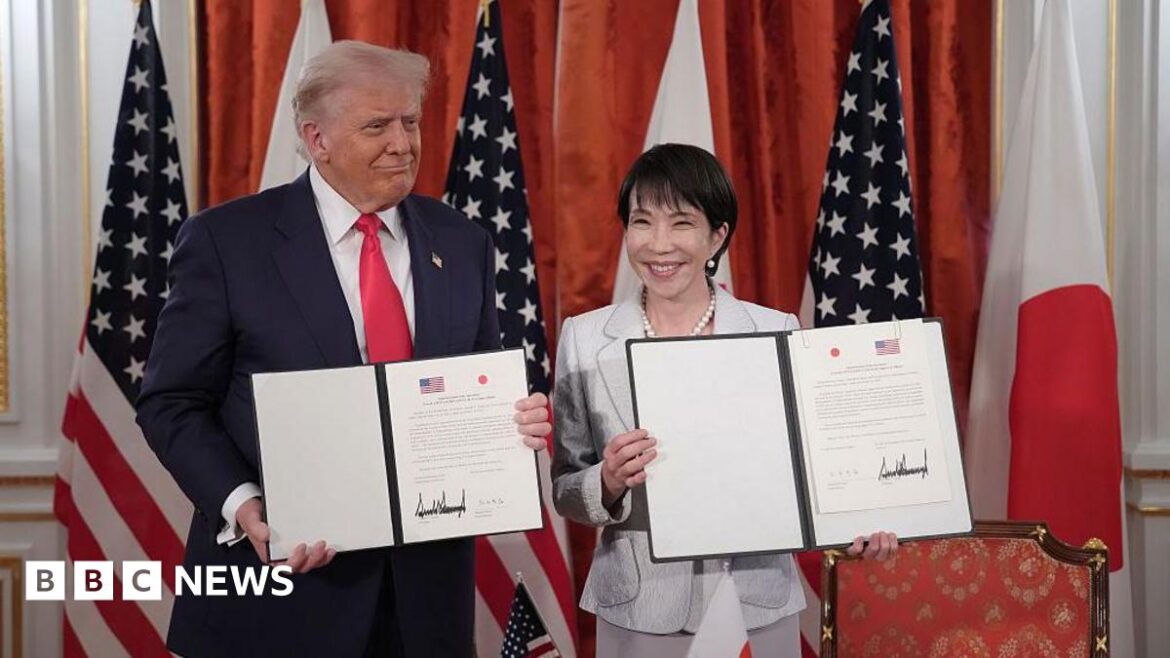US President Donald Trump (L) and Japanese Prime Minister Sanae Takaichi (R) hold up signed documents for an agreement toward a New Golden Age for the U.S.-Japan Alliance during a meeting at Akasaka Palace
