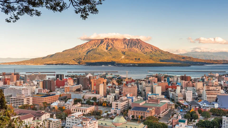 Kagoshima, Japan skyline with Sakurajima Volcano at dusk.